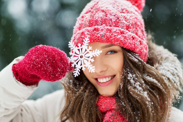 portrait of teenage girl with snowflake in winter stock photo