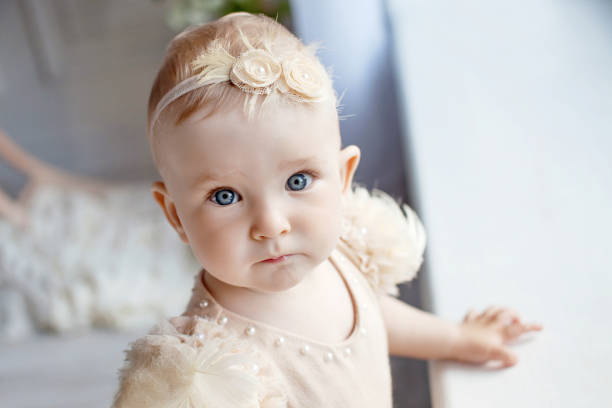 Portrait of the lovely little girl with blue eyes. Serious quiet look stock photo