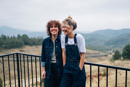 Portrait of Two Happy Female Friends Standing Outdoors