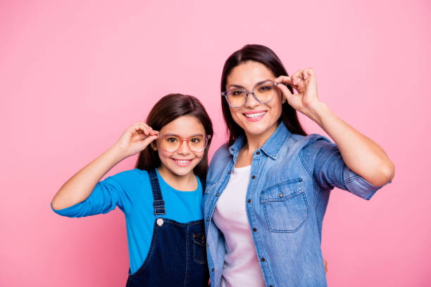 portrait of two nice trendy cute winsome pretty lovely attractive charming cheerful cheery positive straight-haired girls touching glasses lifestyle isolated over pink pastel background - eyeglasses imagens e fotografias de stock
