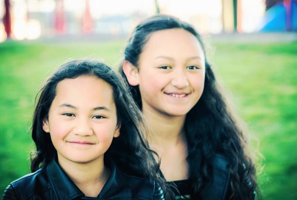 Portrait of two young Maori sisters stock photo