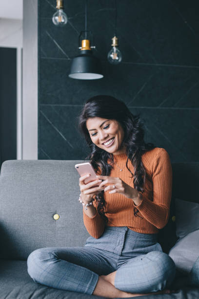 Portrait of woman using her smartphone. Candid portrait of woman using her smartphone. asian woman using phone stock pictures, royalty-free photos & images