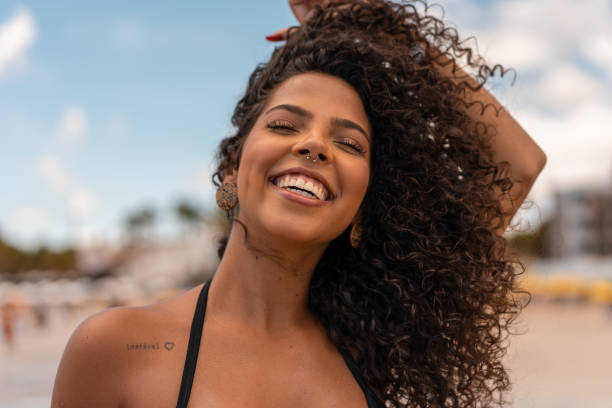 Portrait of woman with nose ring Portrait, Young, Afro, Smiling, Beach curly hair stock pictures, royalty-free photos & images