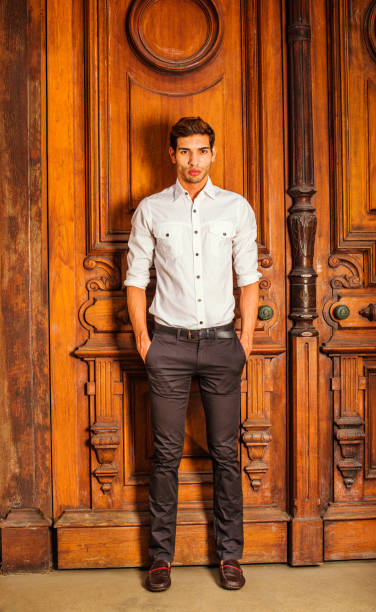 Man Casual Fashion. Wearing a white shirt, black pants, leather...