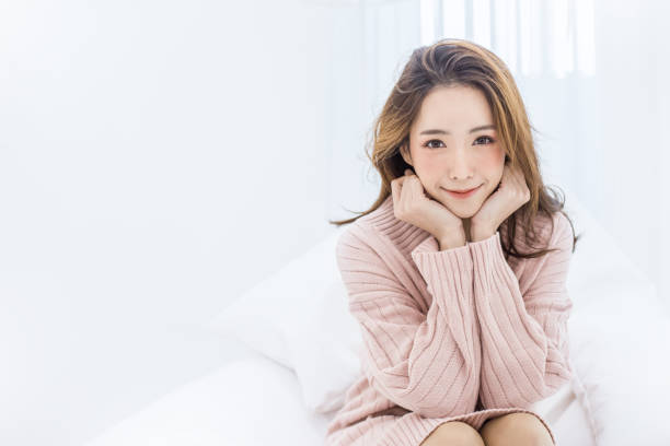 Portrait of young beautiful asian woman relax in her bedroom Portrait of young beautiful asian woman relax in her bedroom. Smile happy asian girl isolated on white background. japanese girl stock pictures, royalty-free photos & images