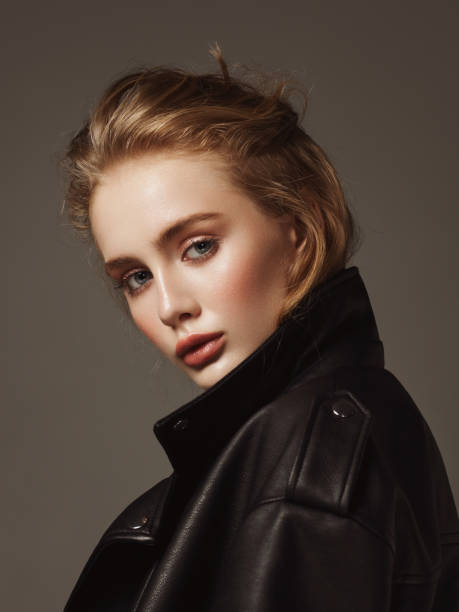 Portrait of young beautiful woman wearing leather jacket stock photo