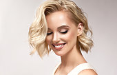 istock Portrait of young blonde middle length haired woman,dressed in a delicate evening makeup.Freshly looking blonde hairstyle. 1308851712