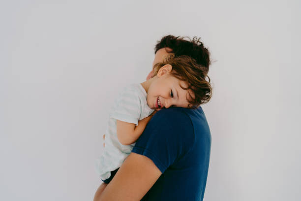 Portrait of young father and his son Photo of young father snuggling with his two year old boy. fathers day stock pictures, royalty-free photos & images