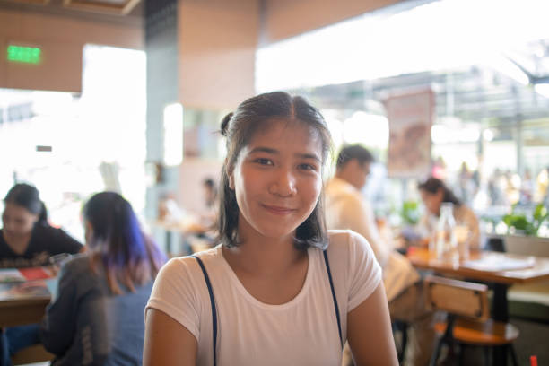 Portrait of young Filipino woman in the morning at cafe Portrait of young Filipino woman in the morning at cafe filipino woman stock pictures, royalty-free photos & images