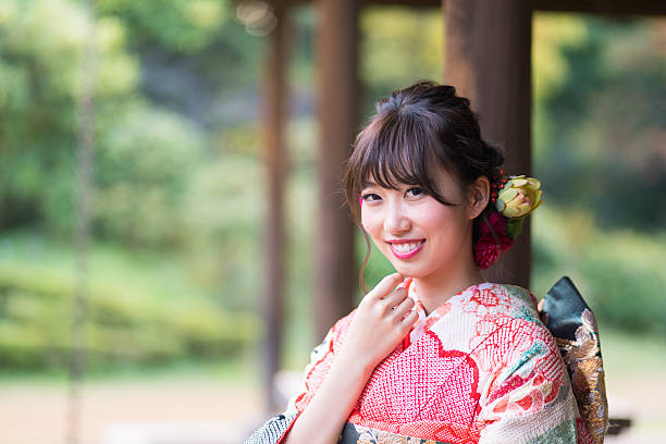 Portrait of young Kimono girl in garden Portrait of young Kimono girl in garden furisode stock pictures, royalty-free photos & images