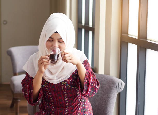 Portrait of young muslim women drinking coffee, relaxing and enjoying her coffee, Muslim concept Portrait of young muslim women drinking coffee, relaxing and enjoying her coffee, Muslim concept hot arabic girl stock pictures, royalty-free photos & images