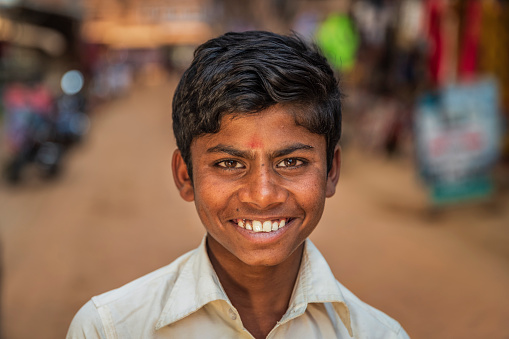 Portrait of young Nepali boy posing in an ancient town of Bhaktapur. Bhaktapur is an ancient town in the Kathmandu Valley and is listed as a World Heritage Site by UNESCO for its rich culture, temples, and wood, metal and stone artwork.