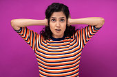 istock Portrait of young women standing isolated over purple background 1329456787