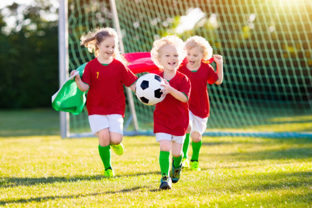 portugal football fan kids. children play soccer. - portugal flag stadium imagens e fotografias de stock