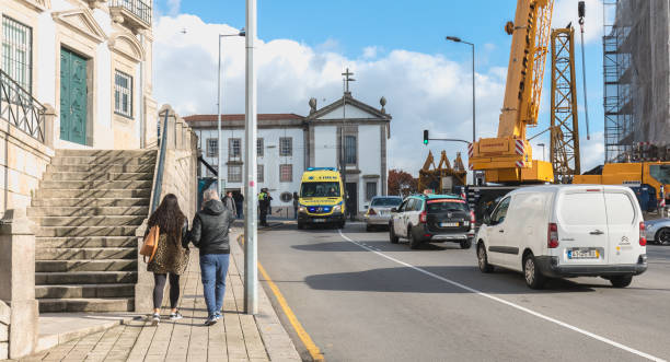 portuguese ambulance passing through the city center of porto, portugal - carro oporto imagens e fotografias de stock