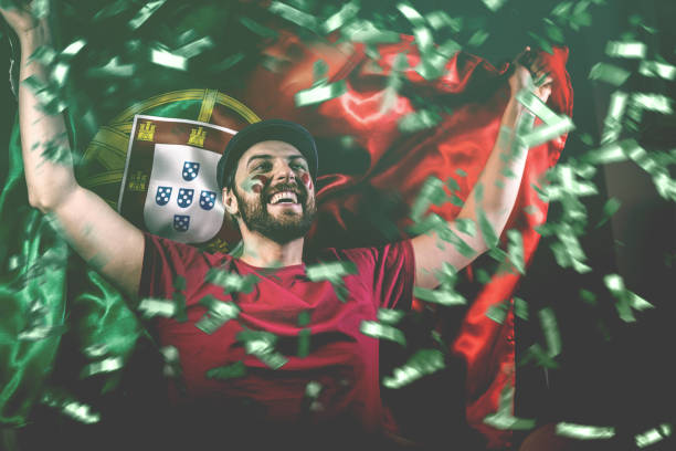 portuguese fan celebrating with the national flag - portugal flag stadium imagens e fotografias de stock