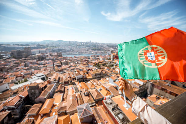 portuguese flag on the porto city background - portugal flag imagens e fotografias de stock