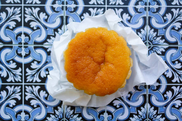 Portuguese typical cake called queijada on portuguese tiles background stock photo