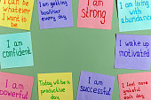 istock Positive affirmations for every day - words on multi-colored on paper for notes on a green background. 1372176758