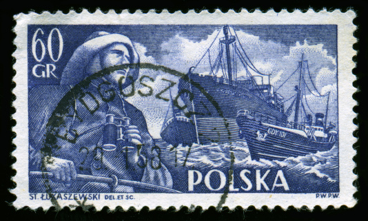 Polish postage stamp with Heroic Fisherman gazing off into the distance. This valiant fellow vaguely resembles the Gortons Fisherman, except This one has binoculars. Boats decorate the background.