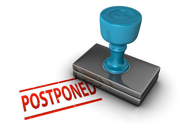 Postponed Stamp A stamp on a white background that reads: Postponed postponed stock pictures, royalty-free photos & images