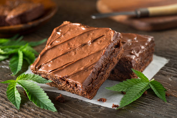Pot Brownies Delicious homemade pot brownies with marijuana leaf garnish. brownie stock pictures, royalty-free photos & images