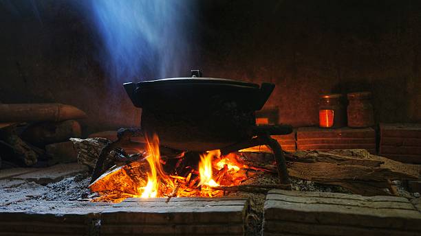 Pot of food on burning wood fire. Rural image pot of food on burning wood fire. camping stove stock pictures, royalty-free photos & images