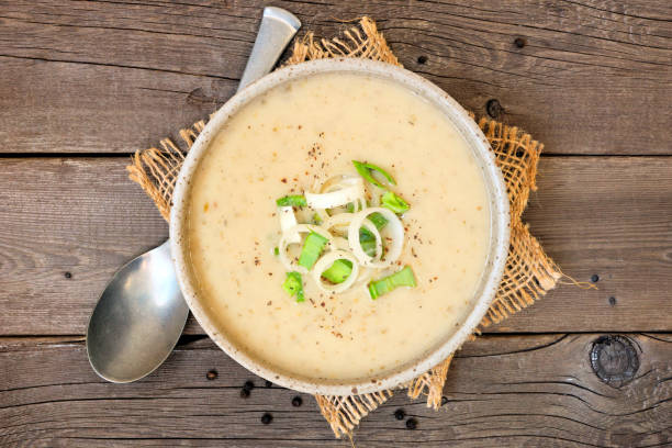 Potato and leek soup, top view table scene on a rustic wood background stock photo