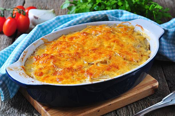 potato casserole with chicken, onions and cheese stock photo