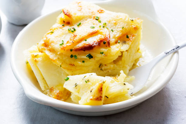 Potato gratin with chives Potato gratin with chives gratin stock pictures, royalty-free photos & images