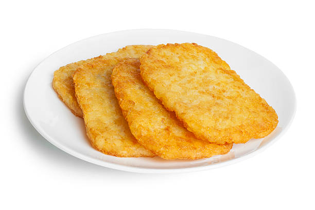 Potato Patties Potato Patties or Hash Browns, front to back focus, isolated on white, clipping path around plate. hash brown photos stock pictures, royalty-free photos & images