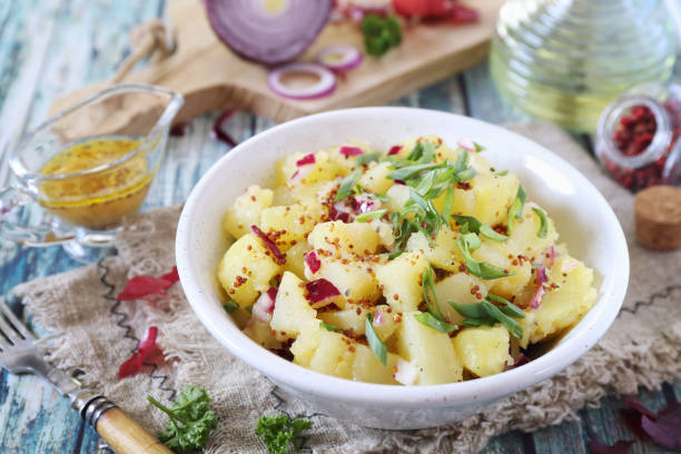 Potato salad with red and green onions, mustard and olive oil spicy sauce stock photo