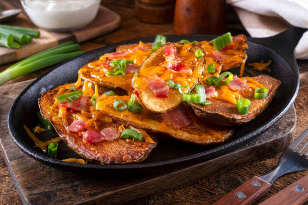 Potato Skins Delicious homemade potato skins with melted cheese, bacon, green onions and sour cream."n prepared potato stock pictures, royalty-free photos & images