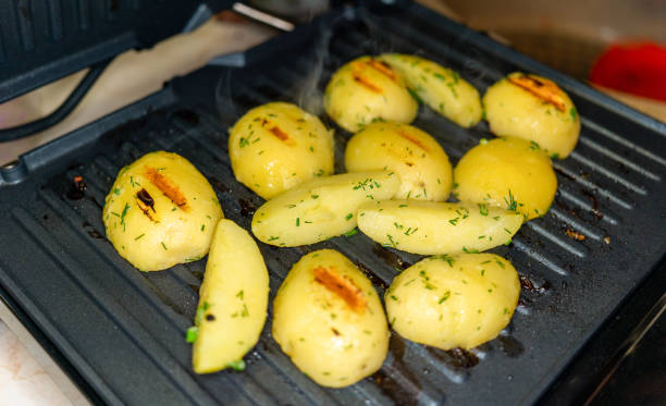 potato slices made on the electric grill stock photo