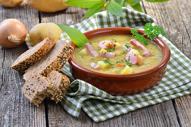 Potato soup Freshly made potato soup with bacon strips and Vienna sausage wheels 7 grain bread photos stock pictures, royalty-free photos & images