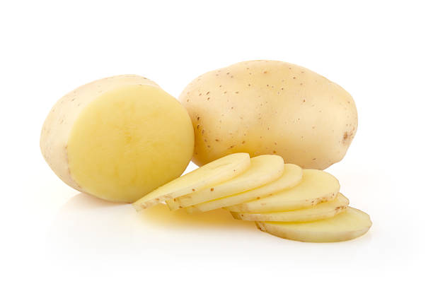 Potatoes and Slices on white Potatoes and Slices isolated on white background prepared potato stock pictures, royalty-free photos & images