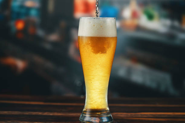 Pouring Beer into Glass stock photo