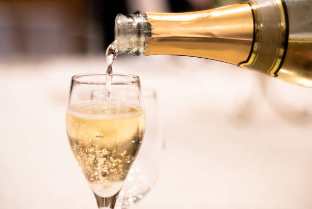 Pouring champagne at the wedding reception banquet stock photo