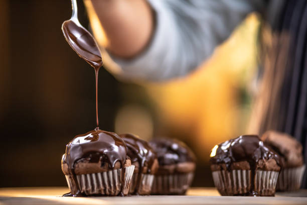 Pouring chocolate Pouring chocolate confectioner stock pictures, royalty-free photos & images