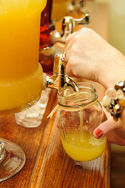 Pouring  drink into a &quot;mason style&quot; jar stock photo