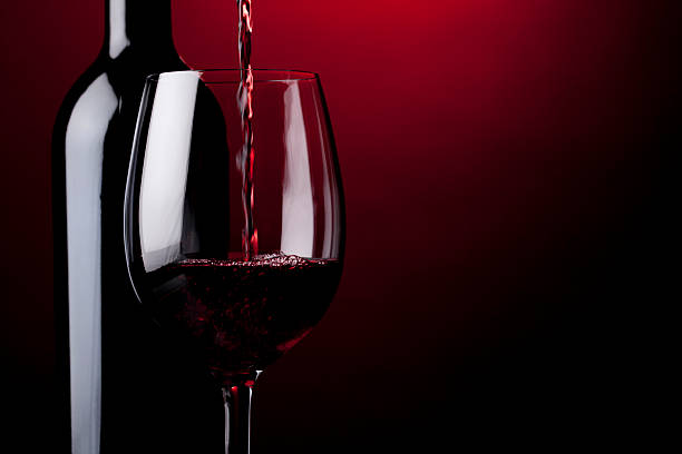 Pouring red wine stock photo