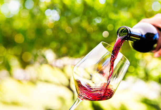 Pouring red wine Pouring red wine into a  wineglass red wine stock pictures, royalty-free photos & images