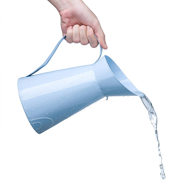 Pouring water from jug isolated stock photo