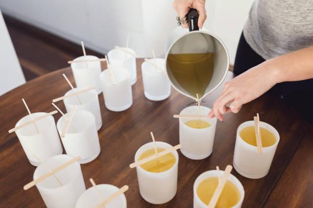 Pouring Wax Into Candle Jars - Candle Making Process stock photo