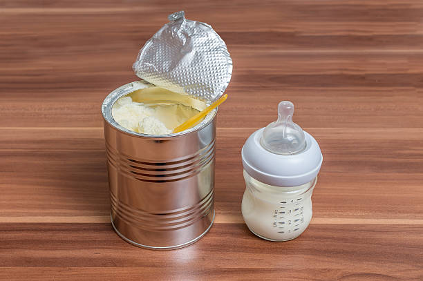 powdered milk formula in can and bottle for feeding baby - baby formula stok fotoğraflar ve resimler
