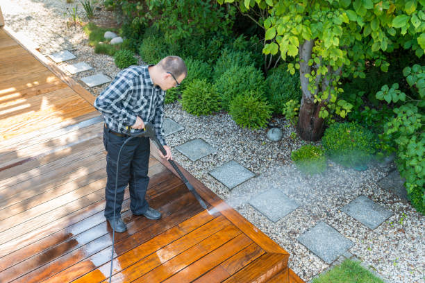 power washing - man cleaning terrace with a power washer - high water pressure cleaner on terrace surface power washing - man cleaning terrace with a power washer - high water pressure cleaner on wooden terrace surface Patio cleaning stock pictures, royalty-free photos & images