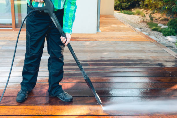 power washing - man cleaning terrace with a power washer - high water pressure cleaner on terrace surface stock photo