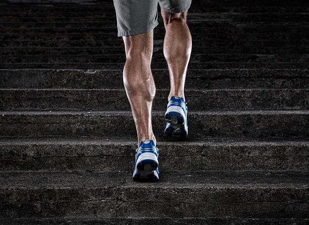 Practice Close up of young man running up the stairs calf stock pictures, royalty-free photos & images