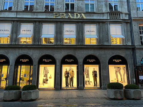Munich, Bavaria Germany - February 22, 2022: Prada high-end fashion store, shop front with logo and window display.