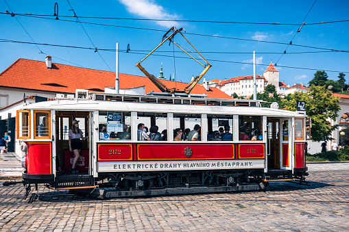 Mala Strana. Czech Republic, Prague, Stare Mesto, end of july 2021. Historic Prague tram departing from the stop. In the background the Prague Castle.